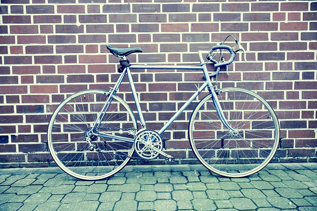 Road bicycle by brick wall